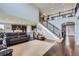 Spacious living room with a staircase leading to the upper level and an open floor plan at 7658 S Country Club Pkwy, Aurora, CO 80016