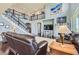 Cozy living room with a fireplace, comfortable seating, and an open staircase to the second floor at 7658 S Country Club Pkwy, Aurora, CO 80016
