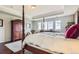 Bright main bedroom featuring tray ceilings, hardwood floors, sitting area, and large windows at 7658 S Country Club Pkwy, Aurora, CO 80016