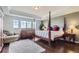 Spacious main bedroom with tray ceilings, hardwood floors, four-poster bed, and large windows at 7658 S Country Club Pkwy, Aurora, CO 80016