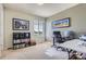 Bright office space with a large window, neutral carpet, contemporary desk, and built-in shelving at 7658 S Country Club Pkwy, Aurora, CO 80016