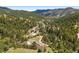 Aerial view of the luxury homes nestled in the mountains amongst the tree tops at 21609 Clarence Ln, Golden, CO 80401
