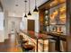 Custom bar with an onyx counter, stacked stone backsplash, and wooden cabinets offers a place to relax at 21609 Clarence Ln, Golden, CO 80401