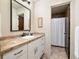Bathroom with vanity, granite countertop, framed mirror, and a separate shower with tiled walls at 21609 Clarence Ln, Golden, CO 80401
