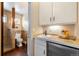 Bright bathroom featuring tile shower, toilet and vanity with built-in storage, and heated hardwood floors at 21609 Clarence Ln, Golden, CO 80401