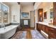 Bright bathroom features dual vanities, modern soaking tub, and contemporary fixtures at 21609 Clarence Ln, Golden, CO 80401