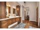 Elegant bathroom with dual vanities, wood cabinets, and modern fixtures at 21609 Clarence Ln, Golden, CO 80401