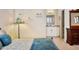 Bedroom with bedside lamp, Tiffany-style floor lamp, and view into bright bathroom at 21609 Clarence Ln, Golden, CO 80401