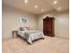 Cozy bedroom featuring carpeted floors and a classic wooden wardrobe at 21609 Clarence Ln, Golden, CO 80401