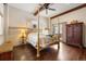 Primary bedroom featuring hardwood floors, canopy bed, wood beams and sliding door to exterior at 21609 Clarence Ln, Golden, CO 80401