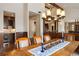 Elegant dining room with a large wood table and decorative chandelier open to other areas of the home at 21609 Clarence Ln, Golden, CO 80401