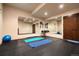 Bright exercise room with mirrors, wall-mounted equipment, and exercise mats on a rubber floor at 21609 Clarence Ln, Golden, CO 80401