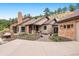 Well-maintained home featuring stone accents, covered porch, and inviting landscaping with a concrete driveway at 21609 Clarence Ln, Golden, CO 80401
