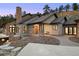 Front exterior of the house showcasing a beautiful stone facade and a well-manicured lawn at 21609 Clarence Ln, Golden, CO 80401