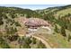 Expansive, multi-level home featuring a long driveway and beautiful landscaping nestled in a serene mountain setting at 21609 Clarence Ln, Golden, CO 80401