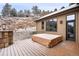 Outdoor deck with covered hot tub and access to inside the house at 21609 Clarence Ln, Golden, CO 80401