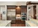 Modern kitchen with stainless steel appliances, dark wood cabinets, and granite countertops at 21609 Clarence Ln, Golden, CO 80401