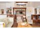 Elegant living room with hardwood floors, beamed ceilings, and view through opening to another living space at 21609 Clarence Ln, Golden, CO 80401