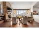 Living room with a stone fireplace, hardwood floors, and expansive windows with scenic views at 21609 Clarence Ln, Golden, CO 80401