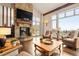 Comfortable living room featuring a stone fireplace, hardwood floors, and large windows showcasing mountain views at 21609 Clarence Ln, Golden, CO 80401