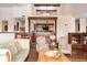 Open concept living room offering hardwood floors, built-in bookshelves, and an open design to the kitchen at 21609 Clarence Ln, Golden, CO 80401