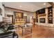 Inviting living room features stone fireplace, custom bar area, and hardwood floors at 21609 Clarence Ln, Golden, CO 80401