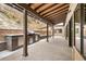 Large covered outdoor kitchen with built-in grill, stainless steel drawers and cabinets, and stone counters at 21609 Clarence Ln, Golden, CO 80401