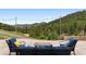 Inviting outdoor patio with comfortable seating and scenic views of the lush green mountains at 21609 Clarence Ln, Golden, CO 80401