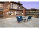 Stone patio with comfortable seating, rock feature, and string lights, perfect for outdoor relaxation at 21609 Clarence Ln, Golden, CO 80401