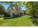 Relax in this beautiful backyard with an expansive lawn and views of the home's architecture at 9278 E Aspen Hill Pl, Lone Tree, CO 80124