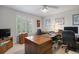 Bright bedroom featuring a large window, two wooden dressers, and a desk at 9278 E Aspen Hill Pl, Lone Tree, CO 80124