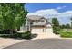 Charming two-story home with stone accents, a three-car garage, and a lush lawn at 9278 E Aspen Hill Pl, Lone Tree, CO 80124