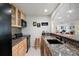 Beautiful open kitchen with wooden cabinets, granite countertops, and modern black appliances at 9278 E Aspen Hill Pl, Lone Tree, CO 80124