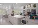 Bright, open kitchen with a large island, white cabinets, and seamless flow into the dining and living areas at 9278 E Aspen Hill Pl, Lone Tree, CO 80124