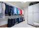 Well-organized walk-in closet with ample hanging space and built-in shelving for optimal storage at 9278 E Aspen Hill Pl, Lone Tree, CO 80124
