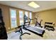 Finished basement with well-equipped home gym, natural light, and space for various exercises at 5126 S Kenton Way, Englewood, CO 80111