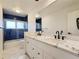 Bathroom featuring a double sink vanity and a tiled shower at 5126 S Kenton Way, Englewood, CO 80111