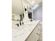 Bright bathroom with double sink vanity with quartz counters and black fixtures at 5126 S Kenton Way, Englewood, CO 80111