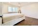 Bright bedroom features neutral tones, a ceiling fan, and large windows for ample natural light at 5126 S Kenton Way, Englewood, CO 80111