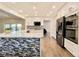 Modern kitchen with stainless appliances, white cabinets, and a mosaic tile backsplash at 5126 S Kenton Way, Englewood, CO 80111
