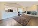 Open concept living room showcasing a brick fireplace and access to the kitchen at 5126 S Kenton Way, Englewood, CO 80111