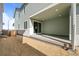 Covered back patio with sliding glass doors and concrete flooring, perfect for entertaining at 5936 N Lisbon St, Aurora, CO 80019
