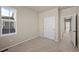 Cozy bedroom with carpet flooring, closet doors, and great natural light through a large window at 5936 N Lisbon St, Aurora, CO 80019