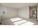 Spacious bedroom with neutral walls, carpet, and an open doorway leading to another room at 5936 N Lisbon St, Aurora, CO 80019