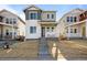 Inviting two-story home featuring a welcoming front porch and meticulously landscaped yard at 5936 N Lisbon St, Aurora, CO 80019