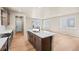 Open kitchen featuring an island with a sink and modern countertops and stainless steel appliances at 5936 N Lisbon St, Aurora, CO 80019