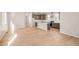 Open concept kitchen and living area with hardwood floors and stainless steel appliances at 5936 N Lisbon St, Aurora, CO 80019