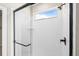 Modern shower features white subway tile, glass enclosure, black trim, and a window at 5936 N Lisbon St, Aurora, CO 80019