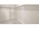 Walk-in closet features neutral carpet, white walls and shelving and rod for organization at 5936 N Lisbon St, Aurora, CO 80019