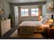 Cozy bedroom with soft carpet, two bright windows, and warm, inviting decor at 656 County Road 72, Bailey, CO 80421